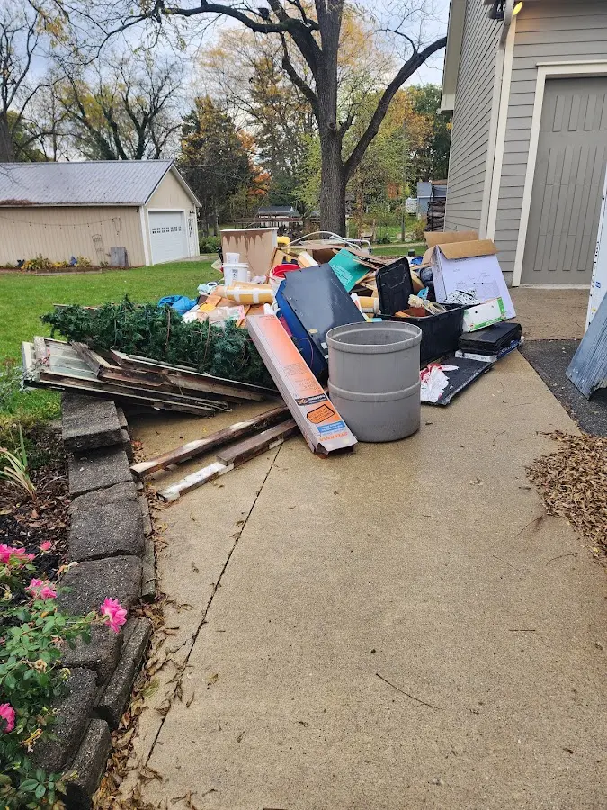 Dumpster being loaded with debris for Estate Cleanout Dumpster Rental in Jamestown